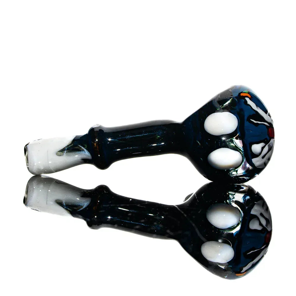 Hand-blown glass spoon pipe with colorful Zero the Dog art, reflective surface