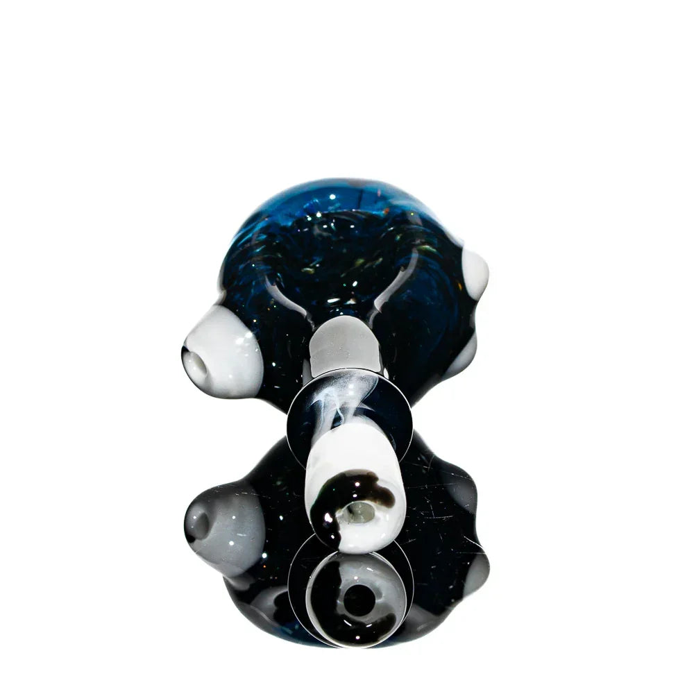 Hand-blown glass art spoon pipe with blue and white accents, reflective background.