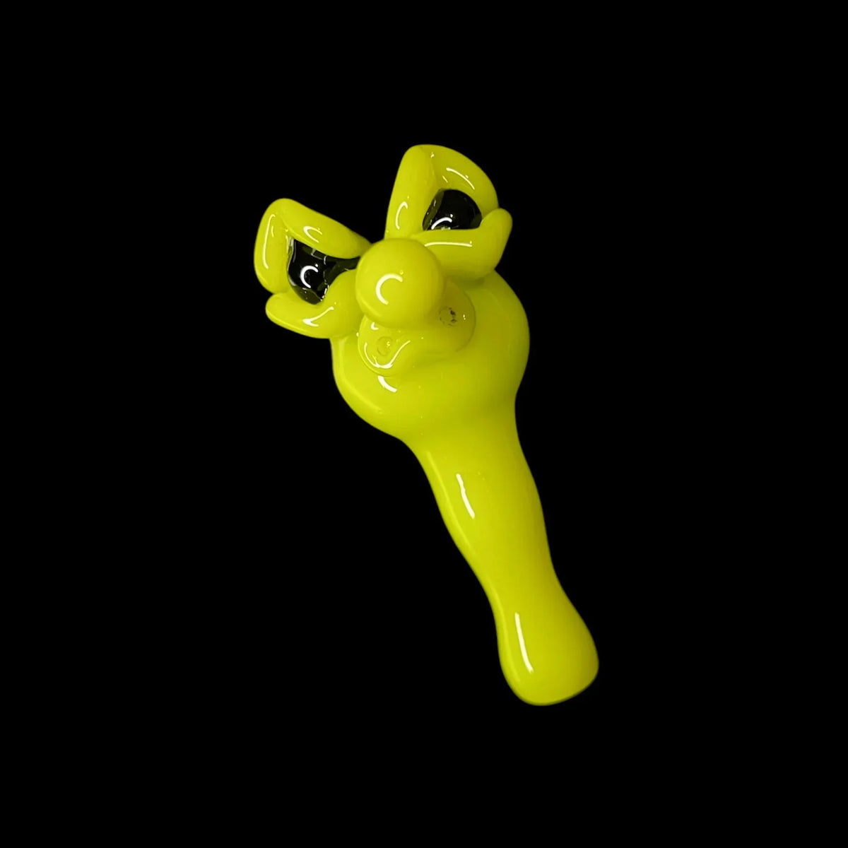 Bright yellow glass joystick cap with cartoon face on black background