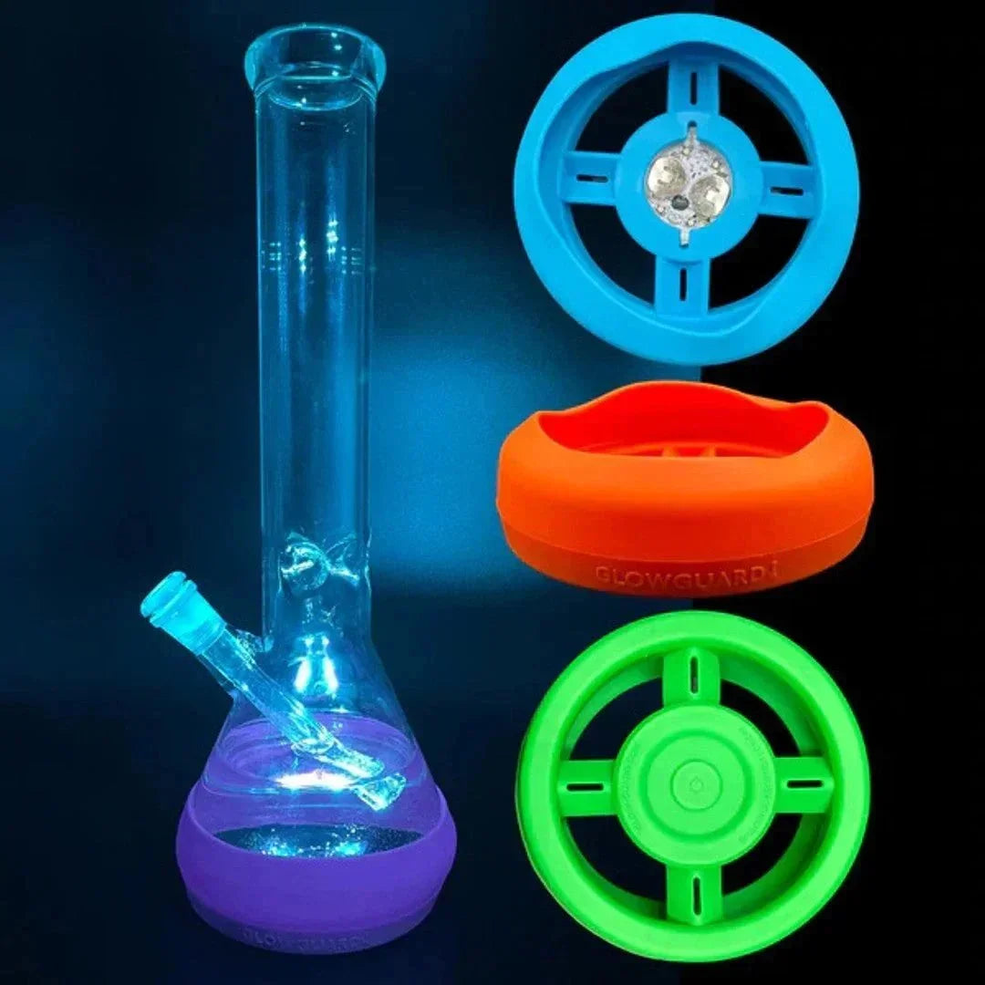 Glass beaker water pipe with colorful silicone protective bases and wheel-style accessories.