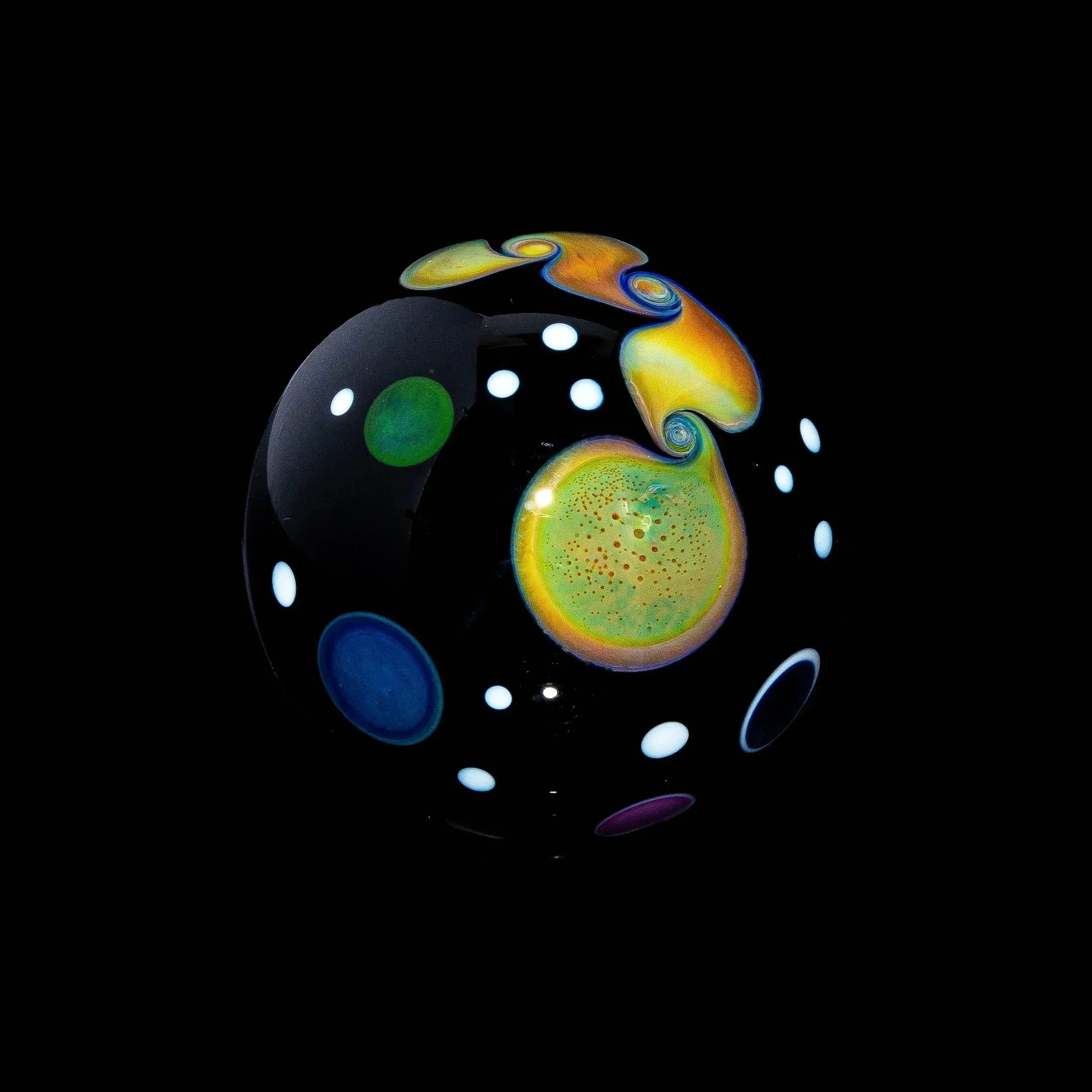 Handcrafted glass marble with colorful planetary and space-inspired designs on black background