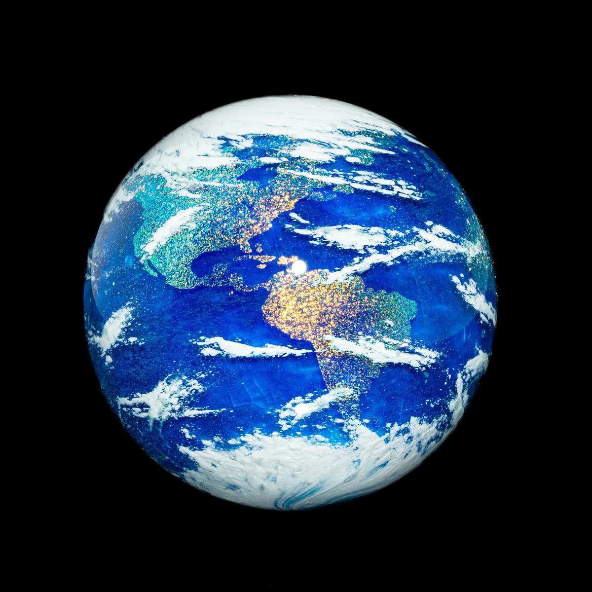 Handcrafted glass Earth globe sculpture with vibrant blue oceans and glitter continents