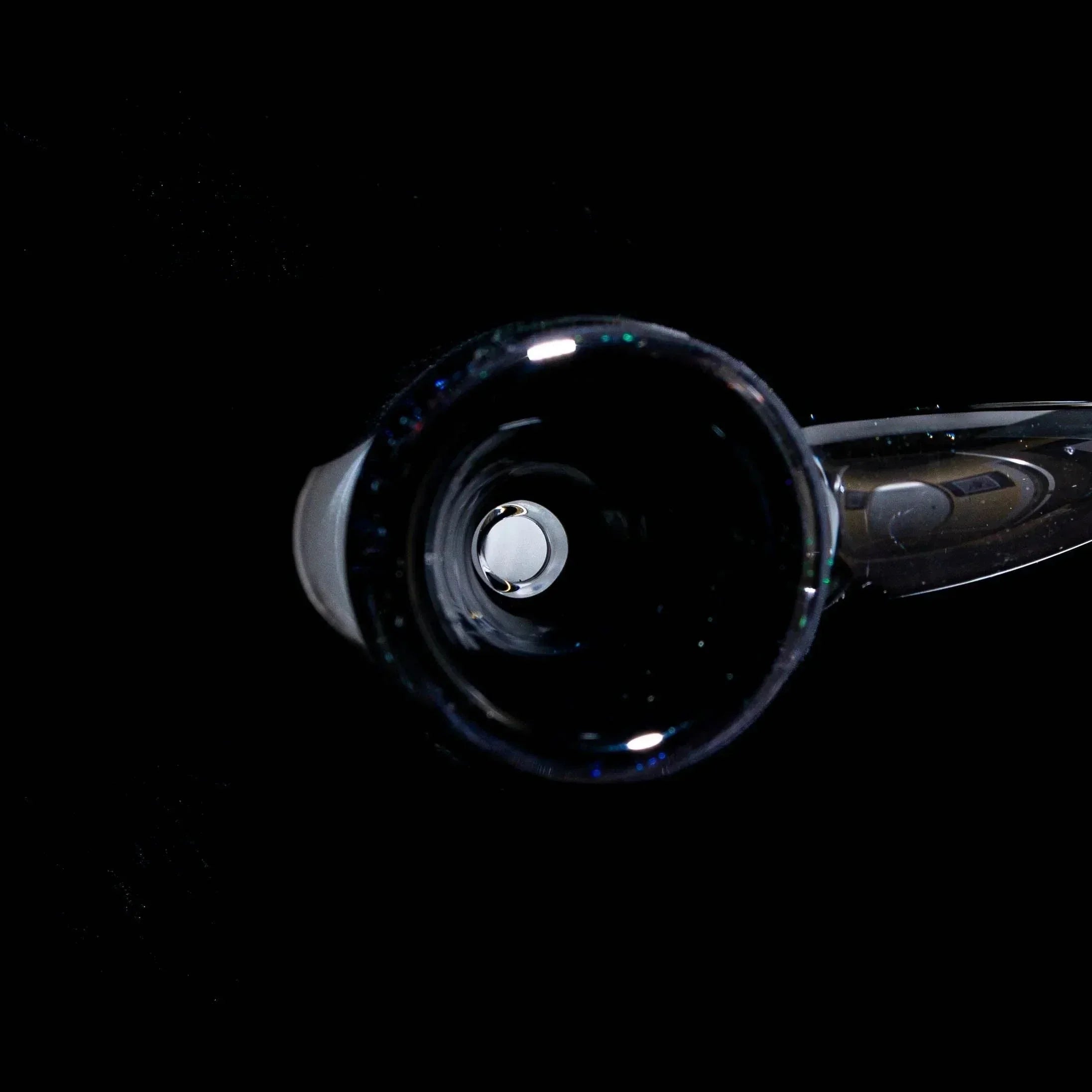 Black rainbow dichro 14mm glass flare slide bowl with iridescent accents on black background