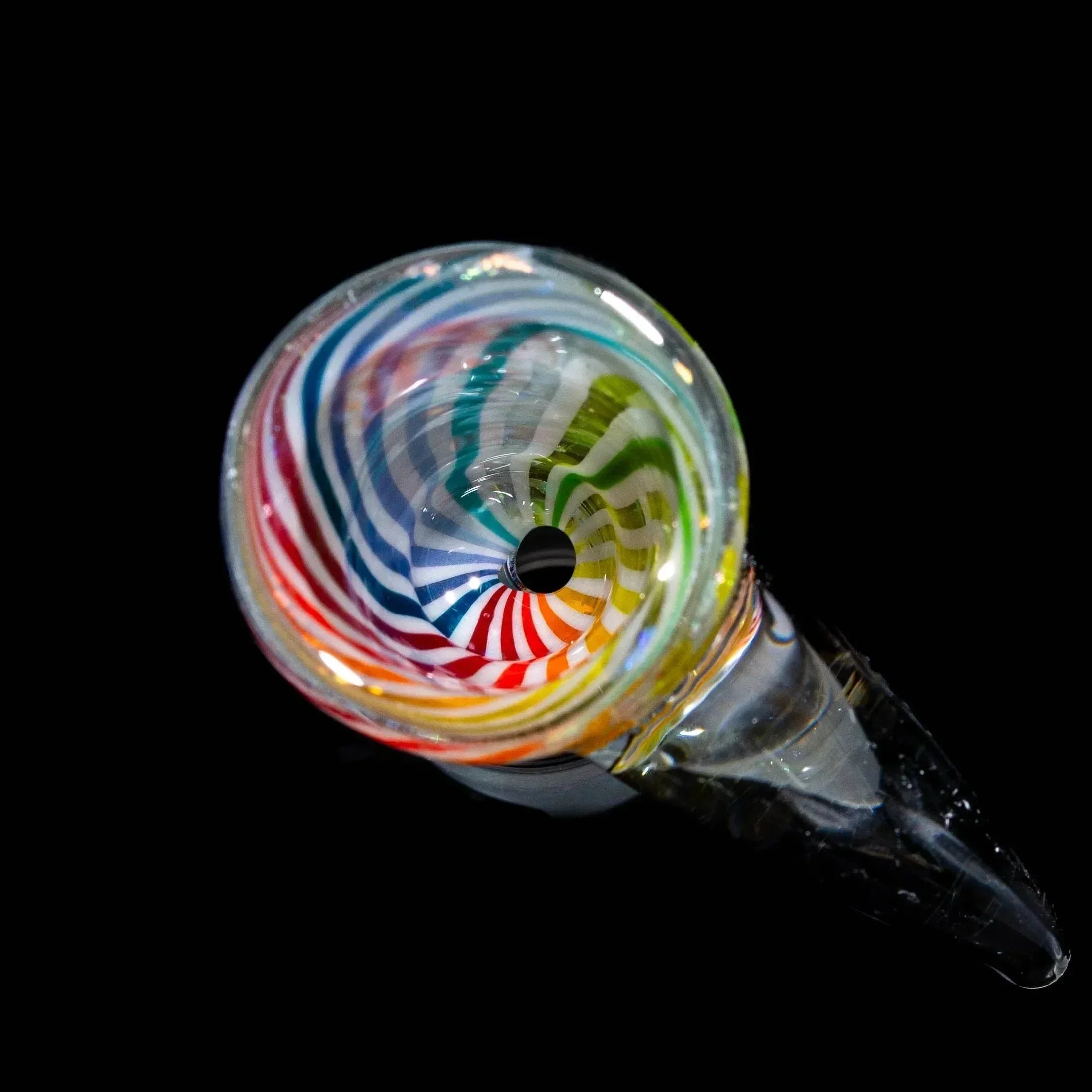 Rainbow swirl dichroic glass bowl slide with flared rim, viewed from above on black background.