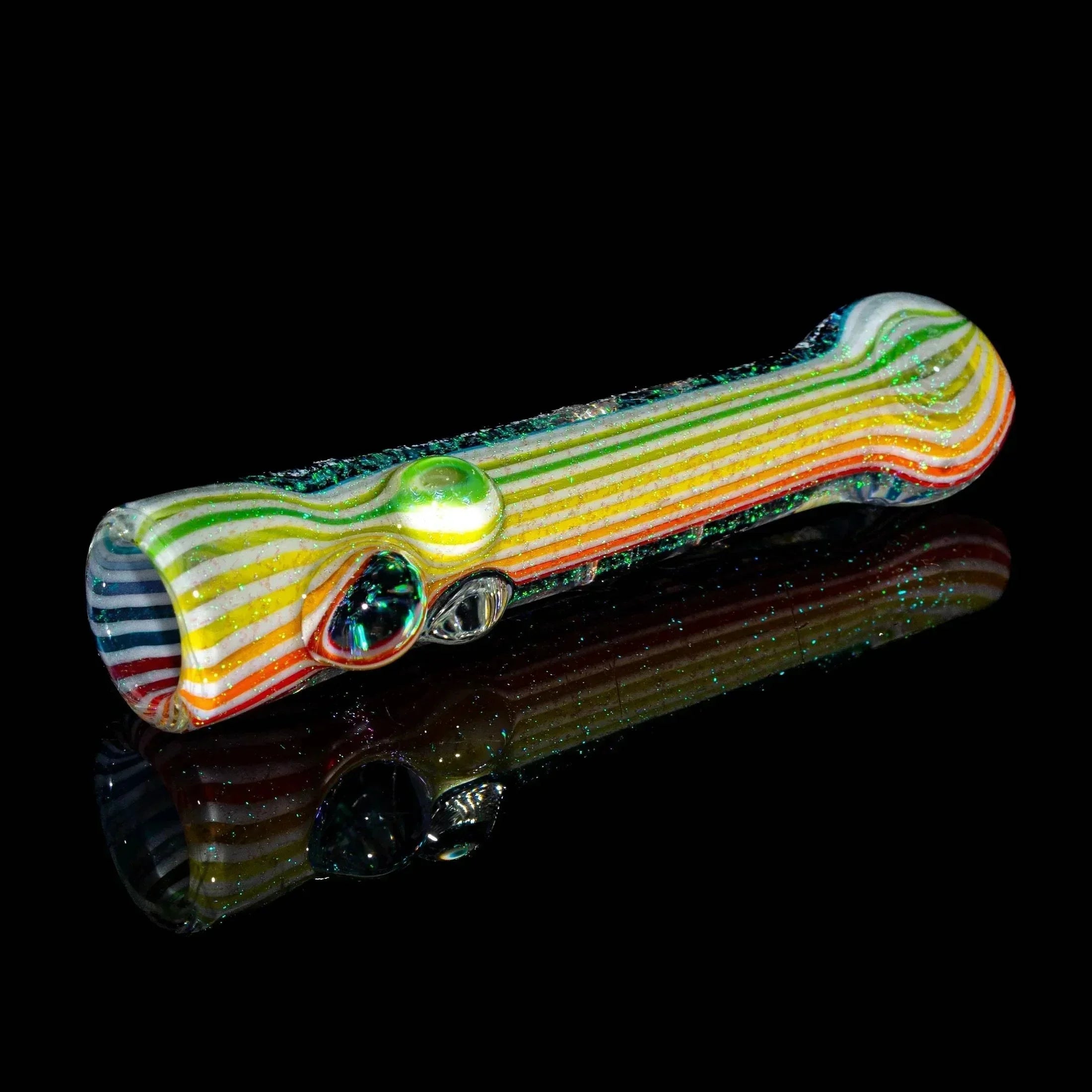 Rainbow striped glass hand pipe with dichroic accents on a black background.