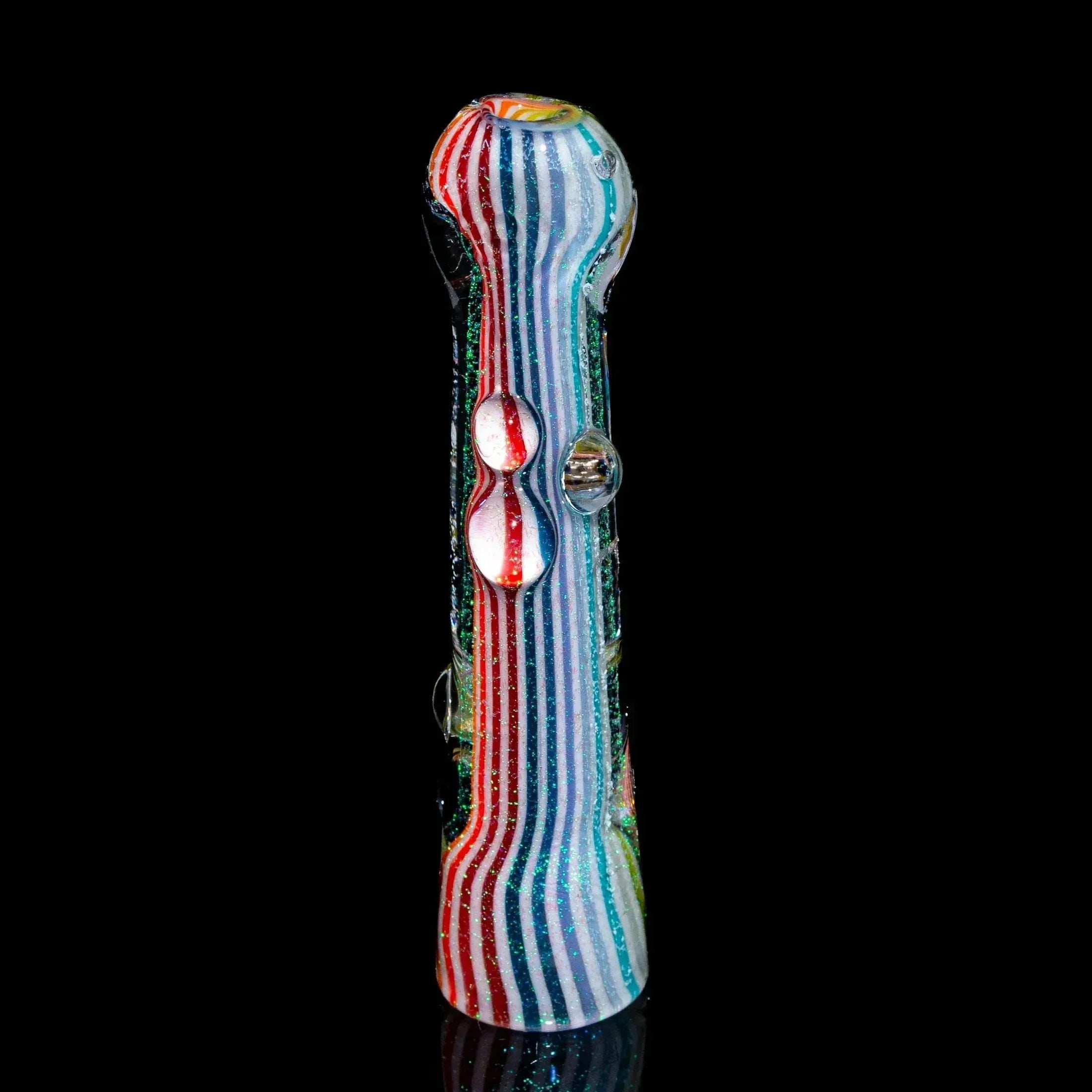 Rainbow striped glass hand pipe with dichroic accents on black background