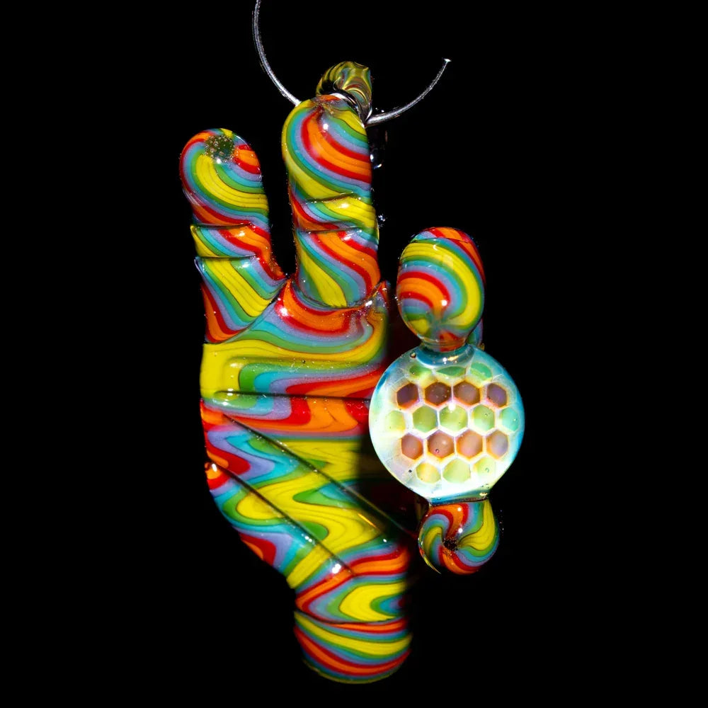 Rainbow glass hand pendant with honeycomb sphere detail on black background