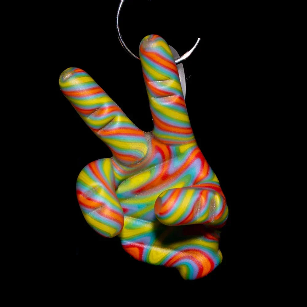 Colorful glass peace sign hand pendant with rainbow swirl pattern on black background