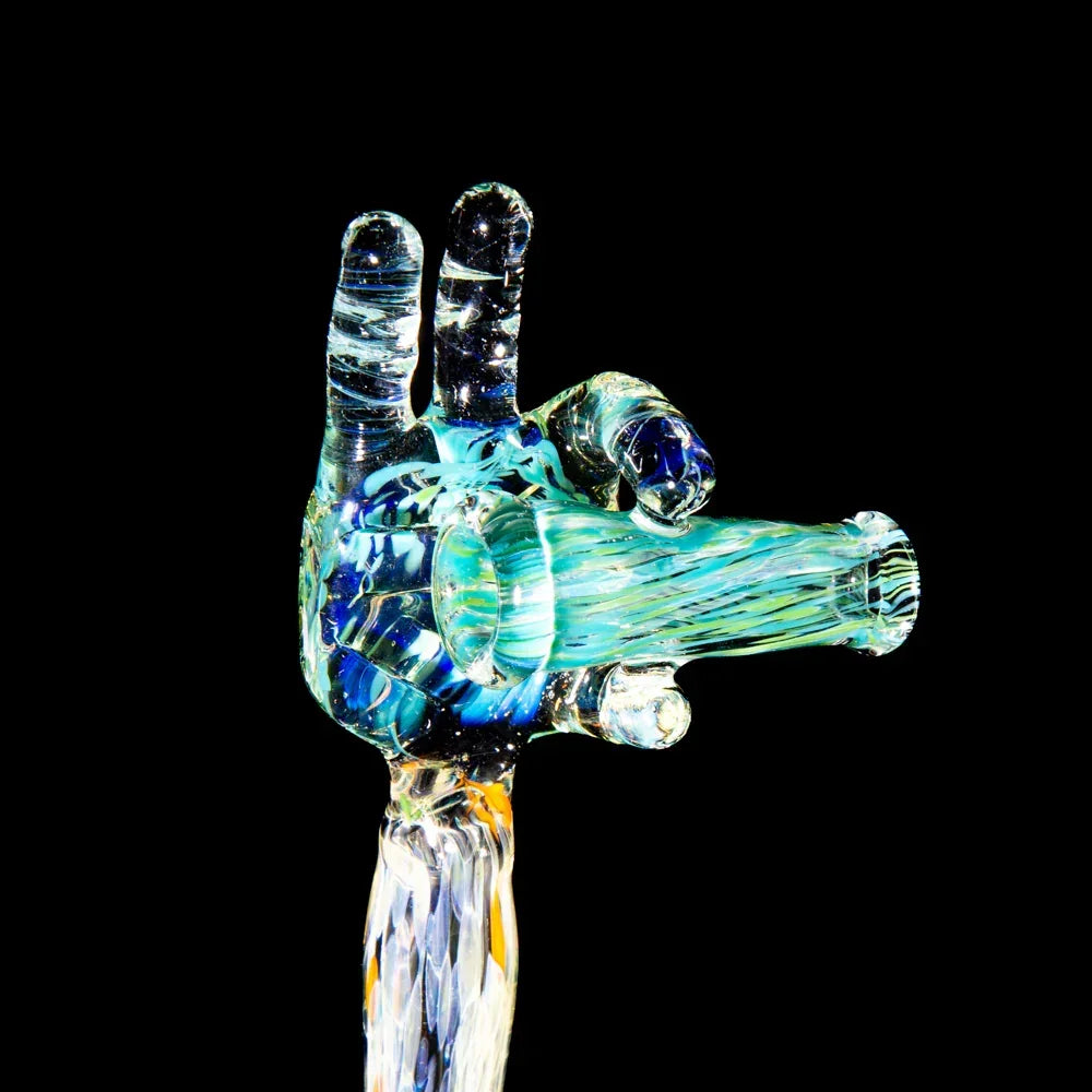 Artistic blue and yellow heady glass hand pipe with intricate details on black background