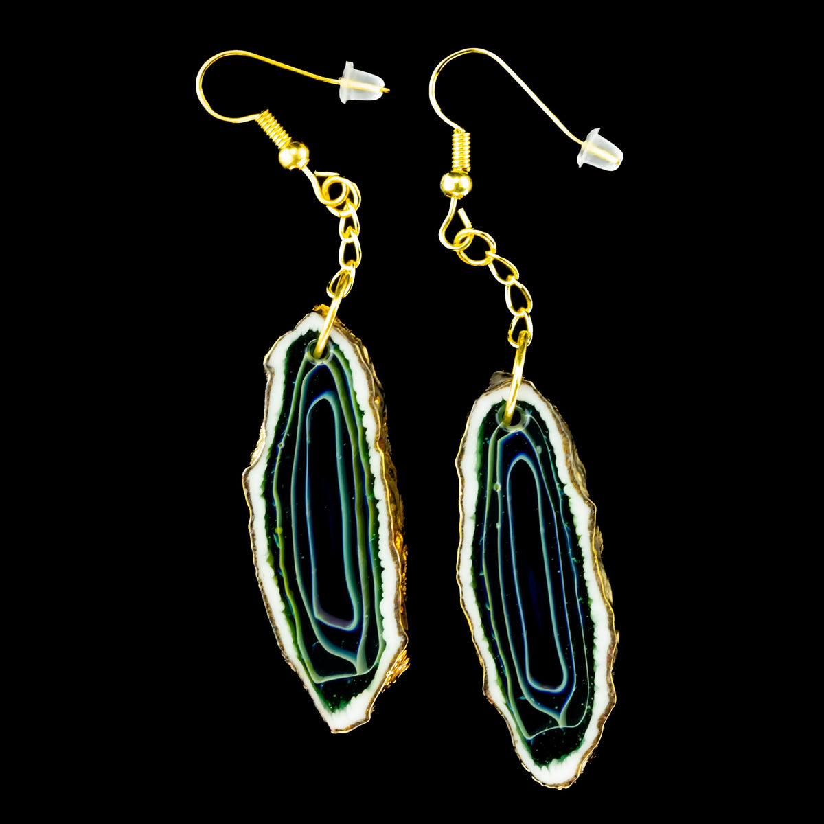 Elongated green and gold agate drop earrings with gold hooks on black background