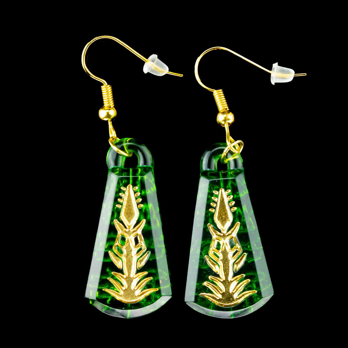 Green glass earrings with gold botanical design and gold hooks on black background