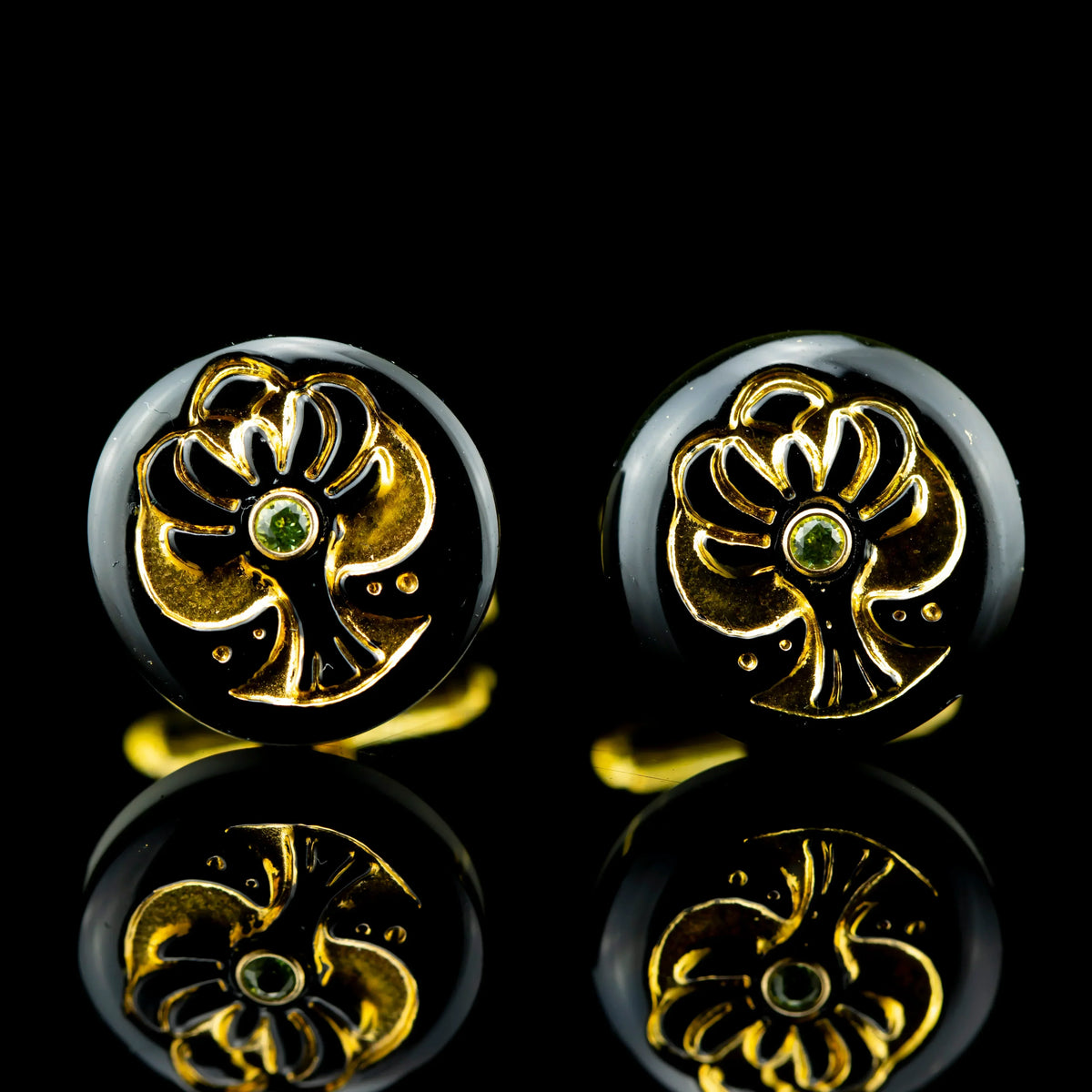 Gold Tree of Life cufflinks with peridot center stone on black background