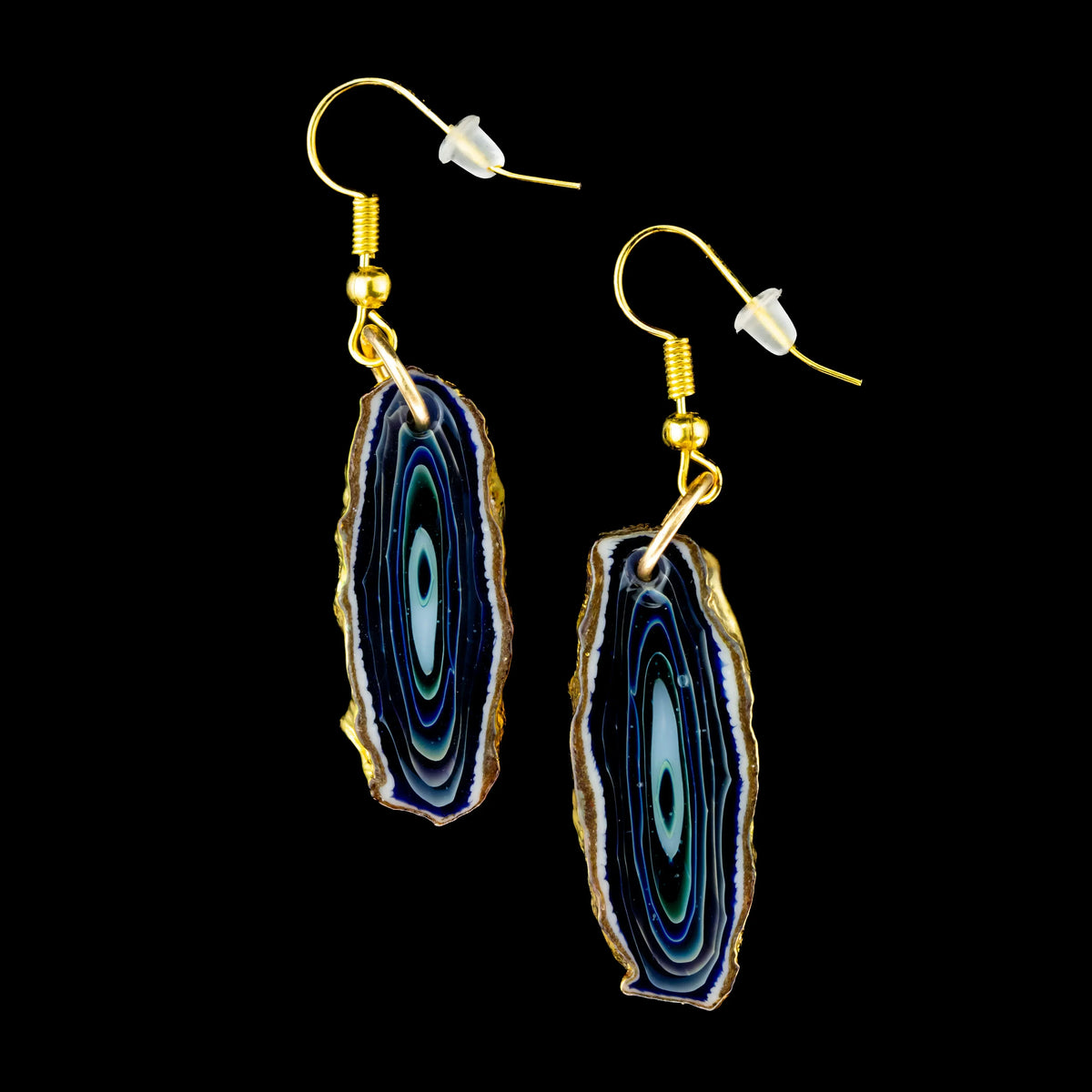 Pair of blue agate slice earrings with gold hooks on black background