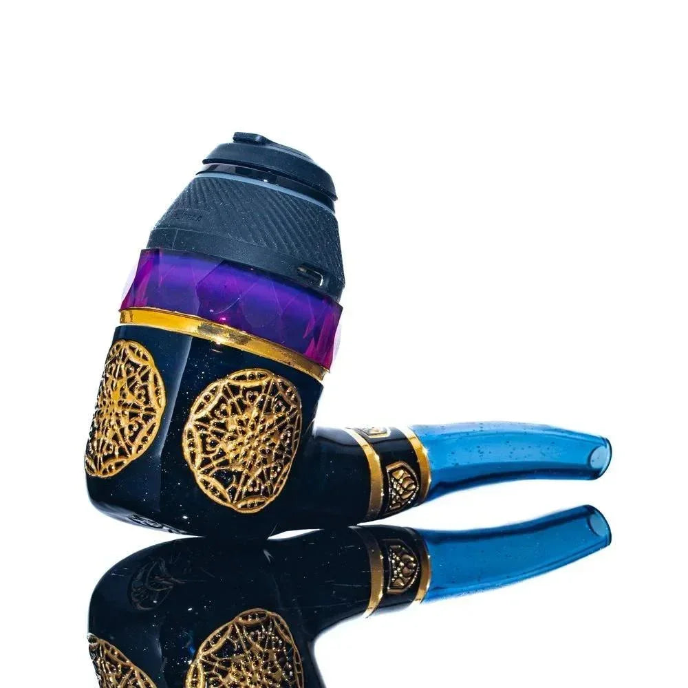 Intricate black and gold glass pipe with purple accent and blue mouthpiece on white background