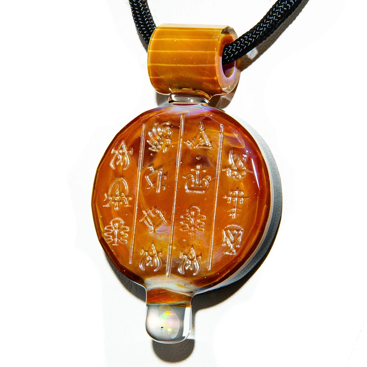 Handmade orange glass pendant with engraved symbols on a black cord, jewelry accessory.