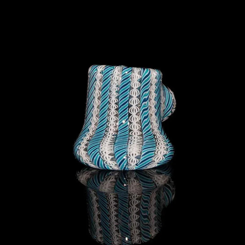 Navy and teal zanfirico glass hand pipe with twisted cane patterns on black background