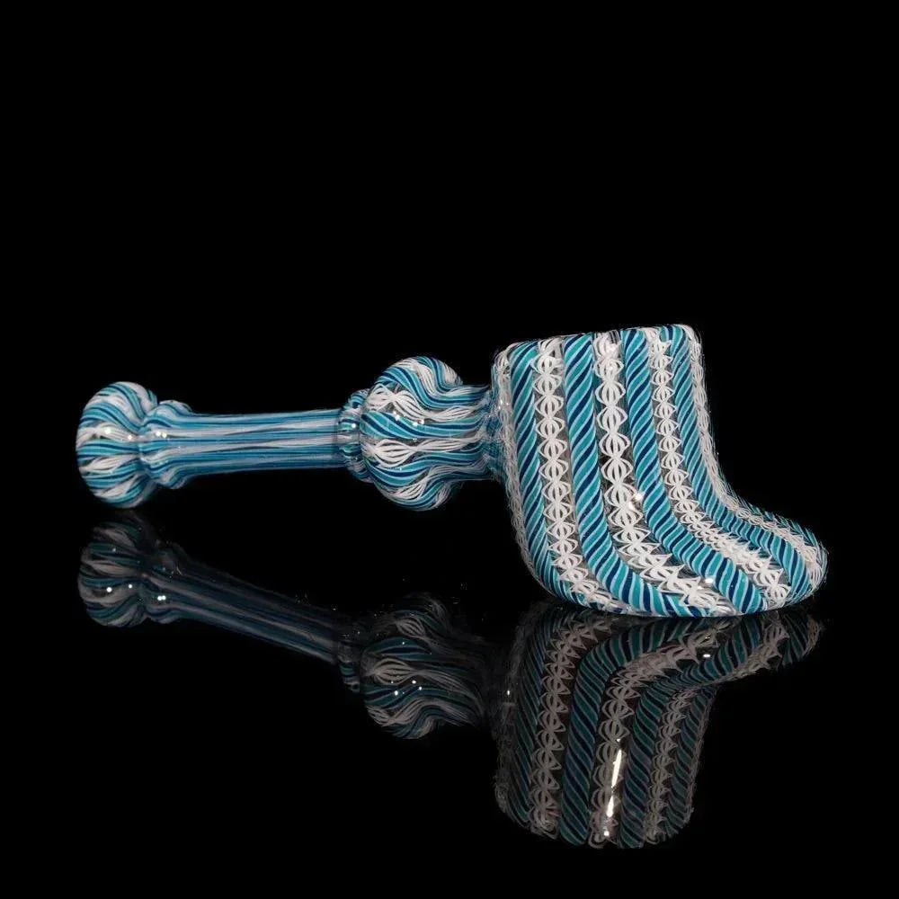Blue and white zanfirico glass hand pipe with intricate swirling patterns on black background