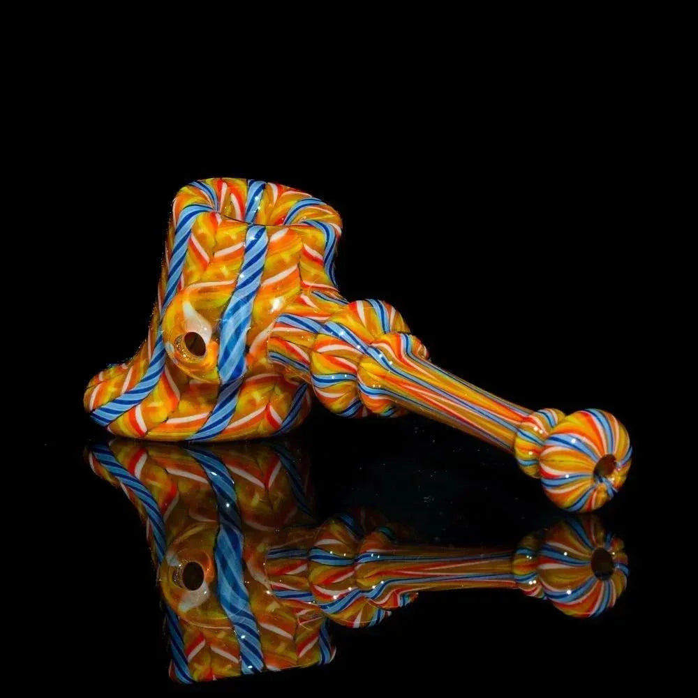 Colorful hand-blown glass hammer pipe with orange, blue, and yellow zanfirico patterns