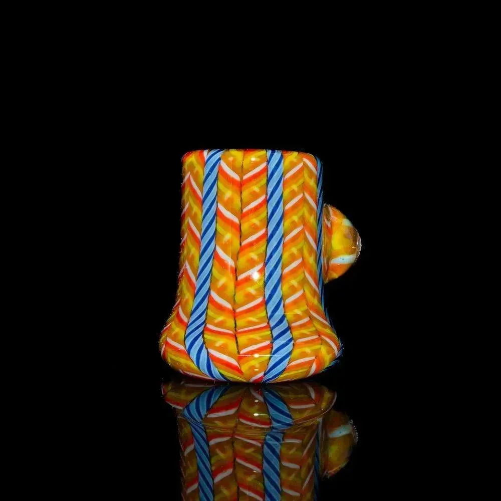 Colorful orange and blue zanfirico glass pocket hammer pipe with chevron patterns on black background