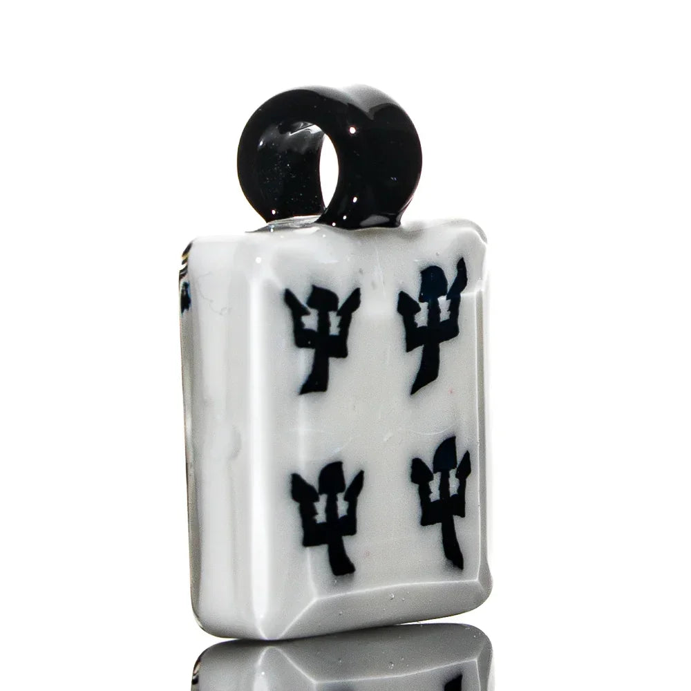 White glass pendant shaped like a tile with black symbols, featuring a black loop bail.