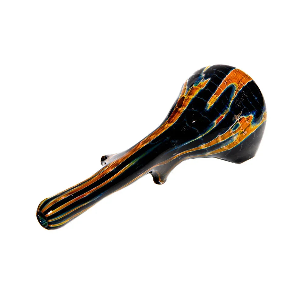 Hand blown glass spoon pipe with black and burnt orange streaks on a white background
