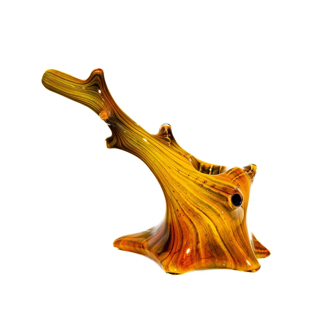 Handcrafted windswept glass spoon pipe with yellow and brown swirled pattern on white background.