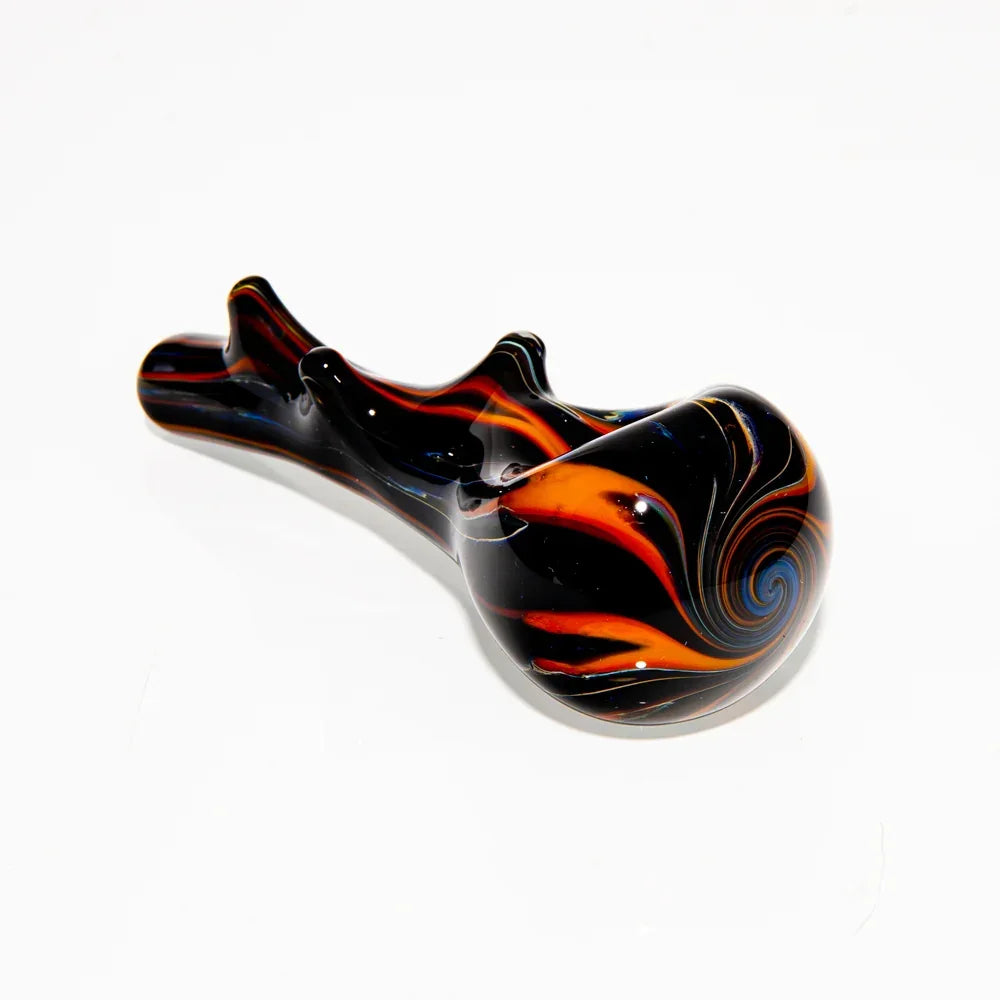 Black glass hand pipe with red and orange swirl design on white background