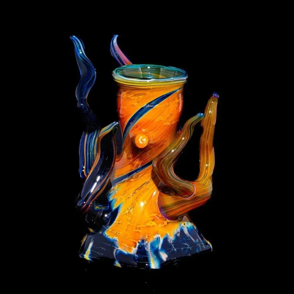 Colorful heady glass water pipe with swirling orange, blue, and marble accents on black background