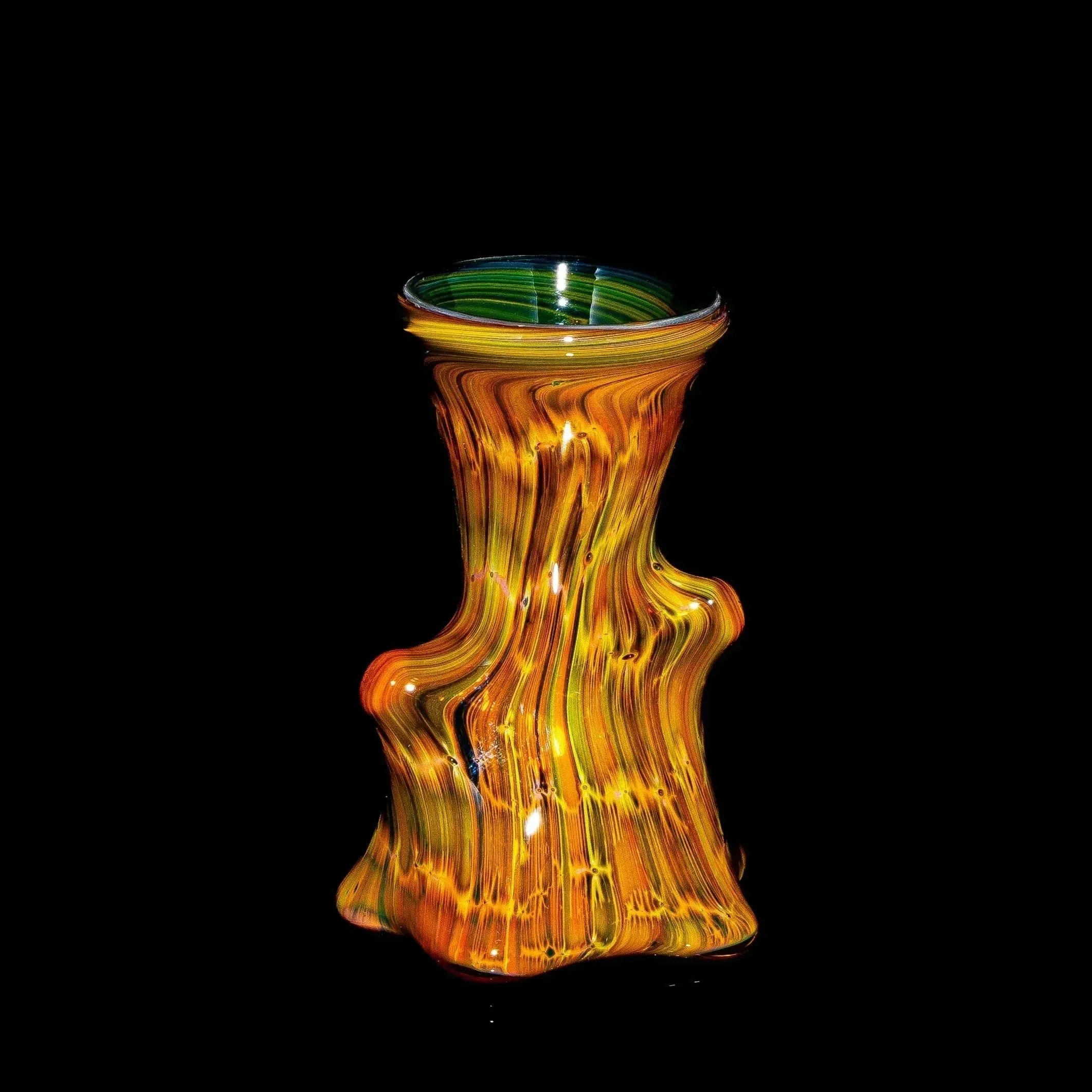 Hand-blown glass pipe with orange and yellow swirled patterns on a black background