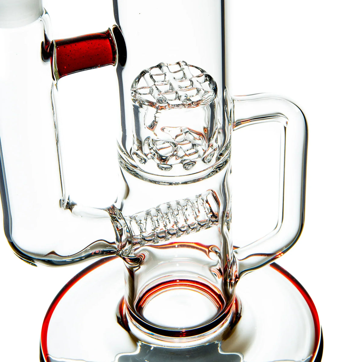 Close-up of a clear glass water pipe with intricate percolator and red accent details