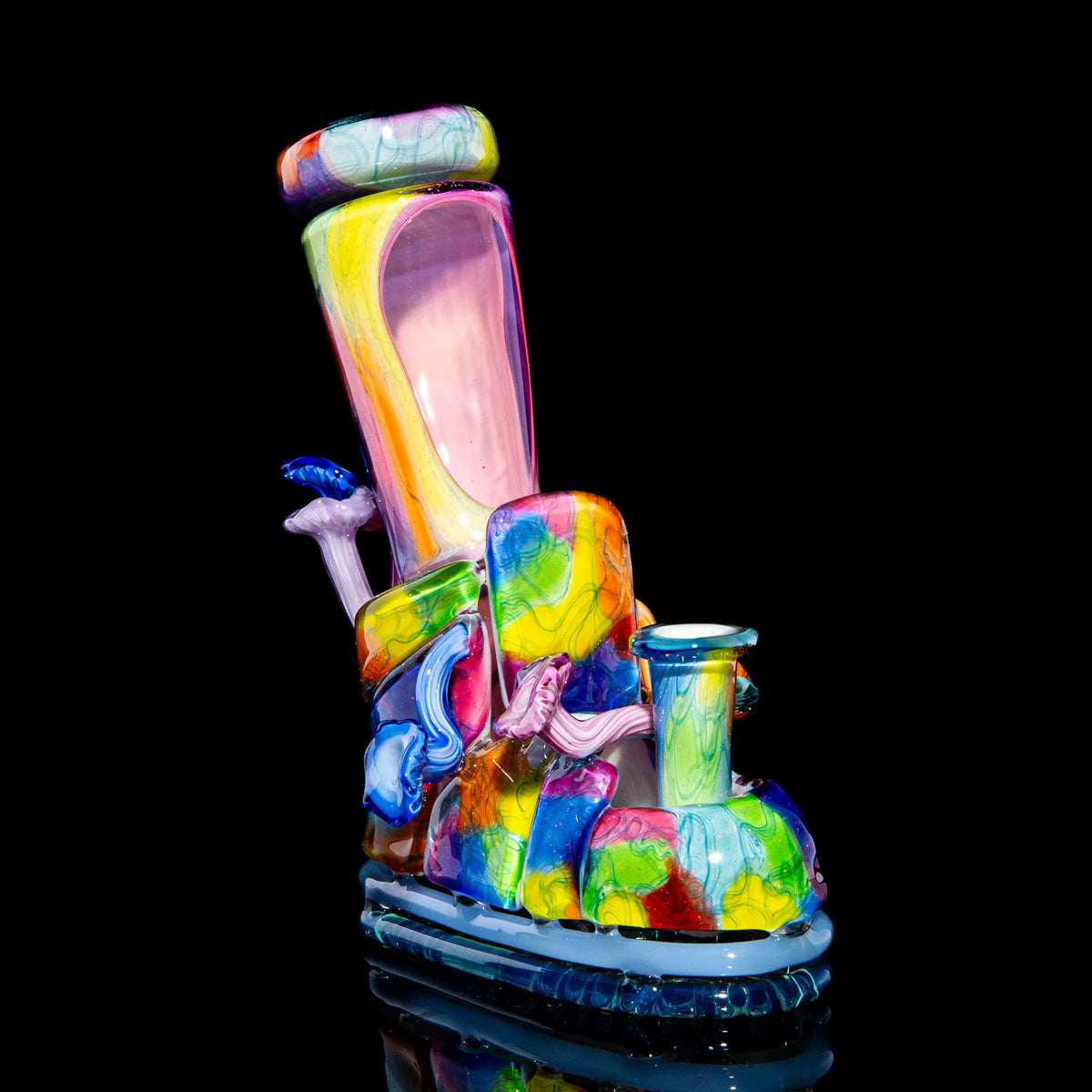 Colorful heady glass art pipe shaped like a boot with mushroom and swirl details on black background