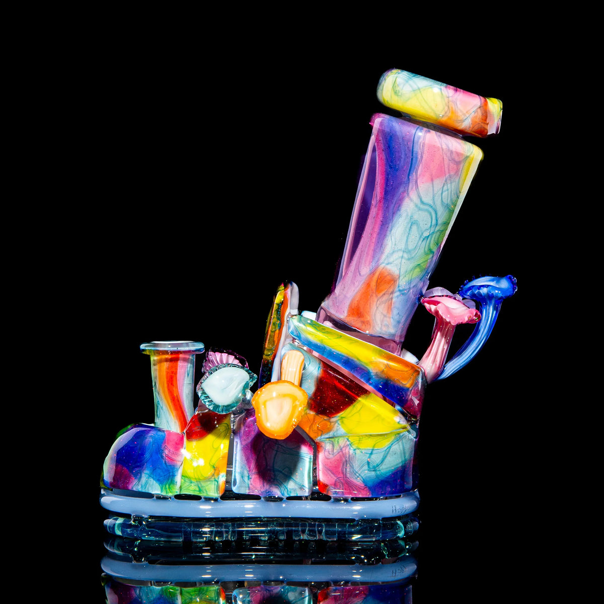 Colorful abstract glass art pipe shaped like a boot, with intricate patterns and accents