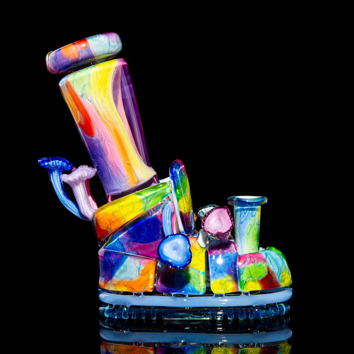 Heady glass water pipe with vibrant rainbow swirls and mushroom accents on black background