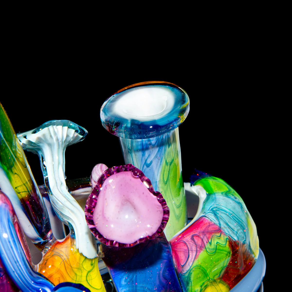 Colorful heady glass sculpture with mushroom-inspired designs on black background