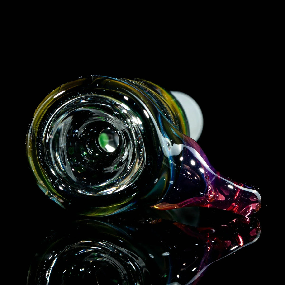 Colorful hand-blown glass pipe with swirl design on black reflective surface