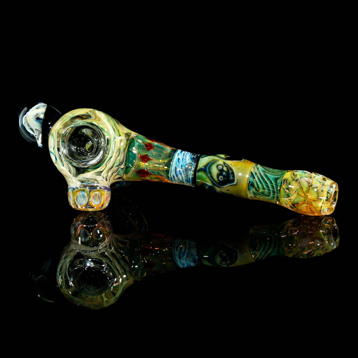 Heady glass hand pipe with colorful patterns and unique artwork, displayed on black background