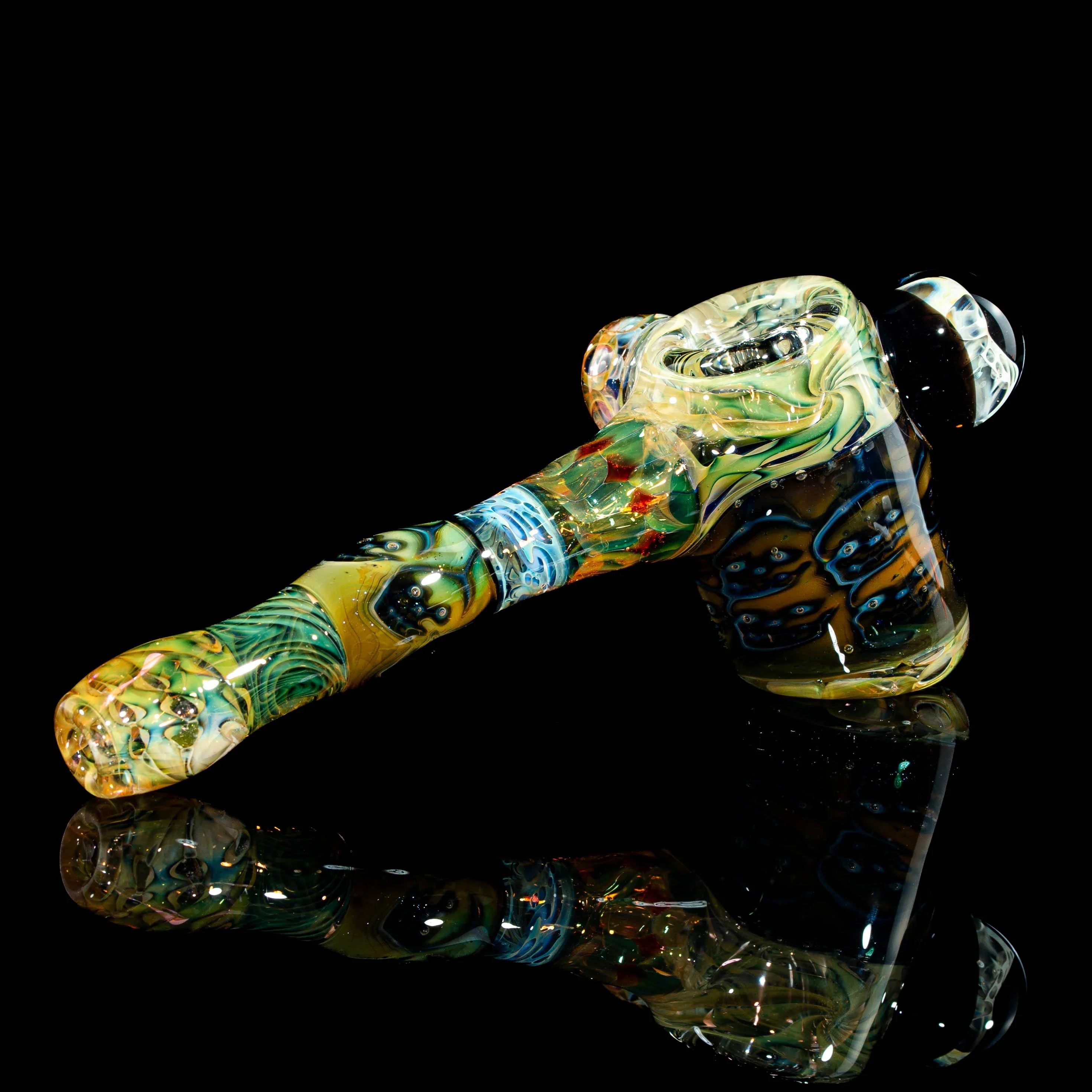 Colorful heady glass hand pipe with intricate designs on black background