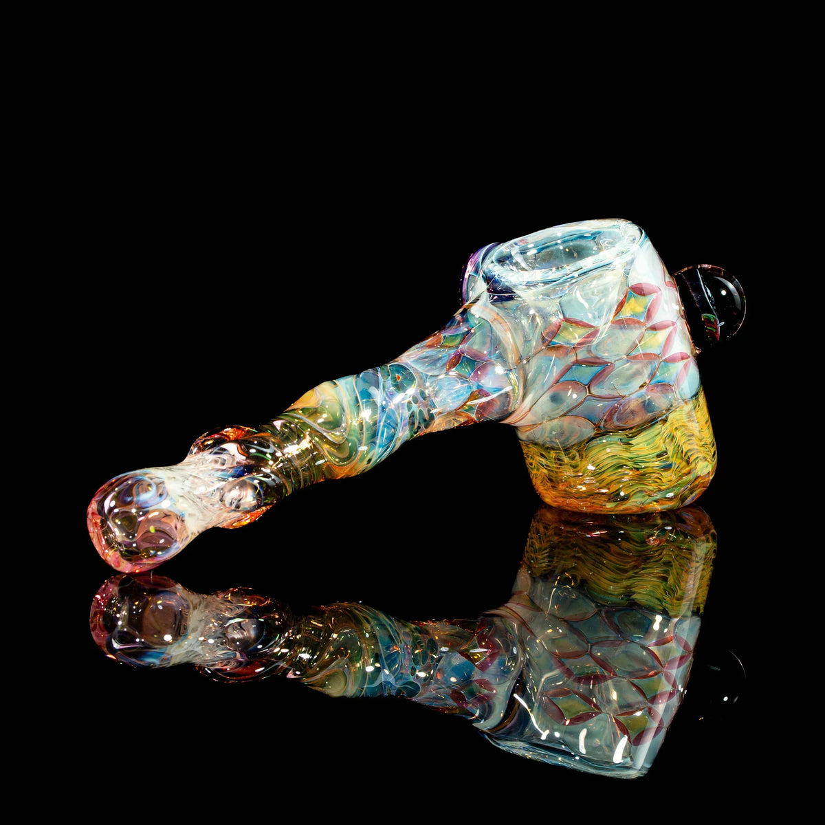 Handcrafted colorful glass pipe with intricate patterns on a black reflective surface