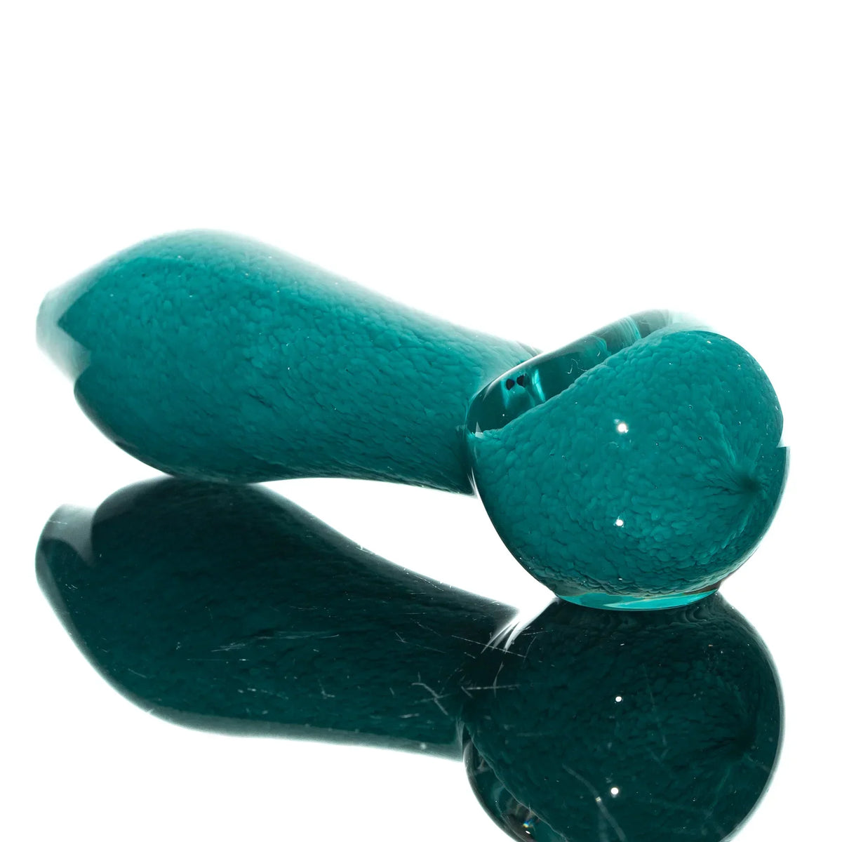 Aqua blue glass hand pipe with frit texture, displayed on a reflective surface