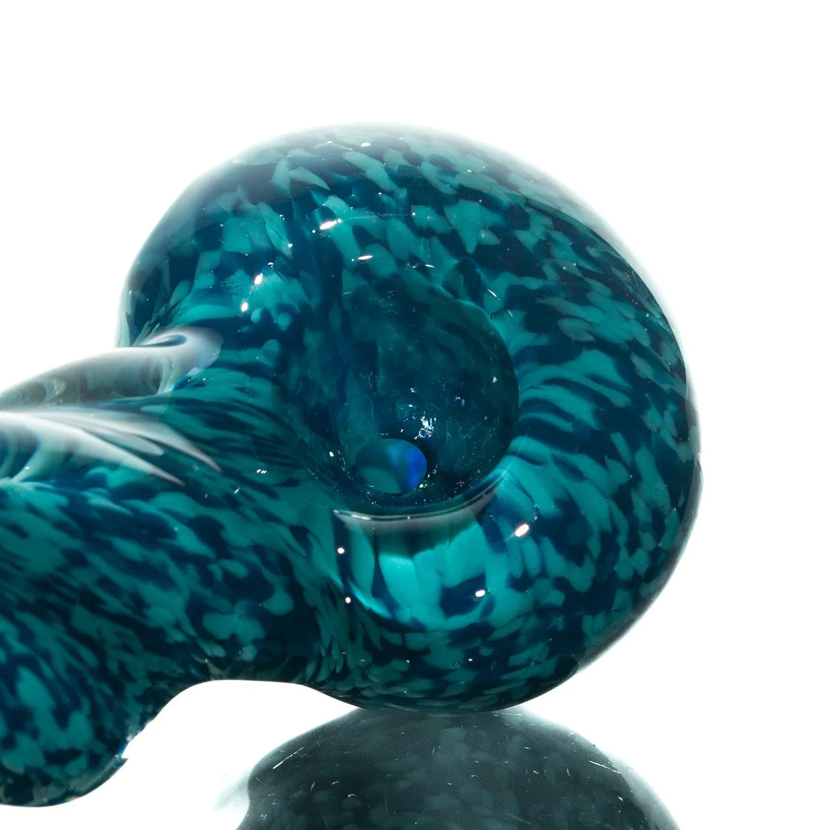 Close-up of a blue teal fritted glass hand pipe with a twisted spoon shape