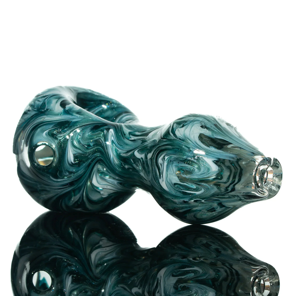 Blue Stardust glass pipe with white swirl design on reflective surface