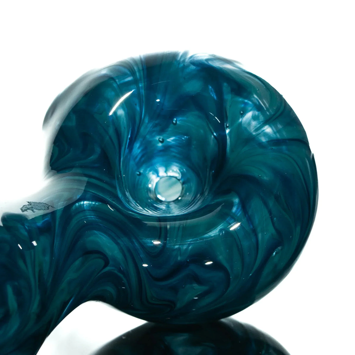 Hand-blown blue and teal glass spoon pipe with swirled marbled design, close-up view