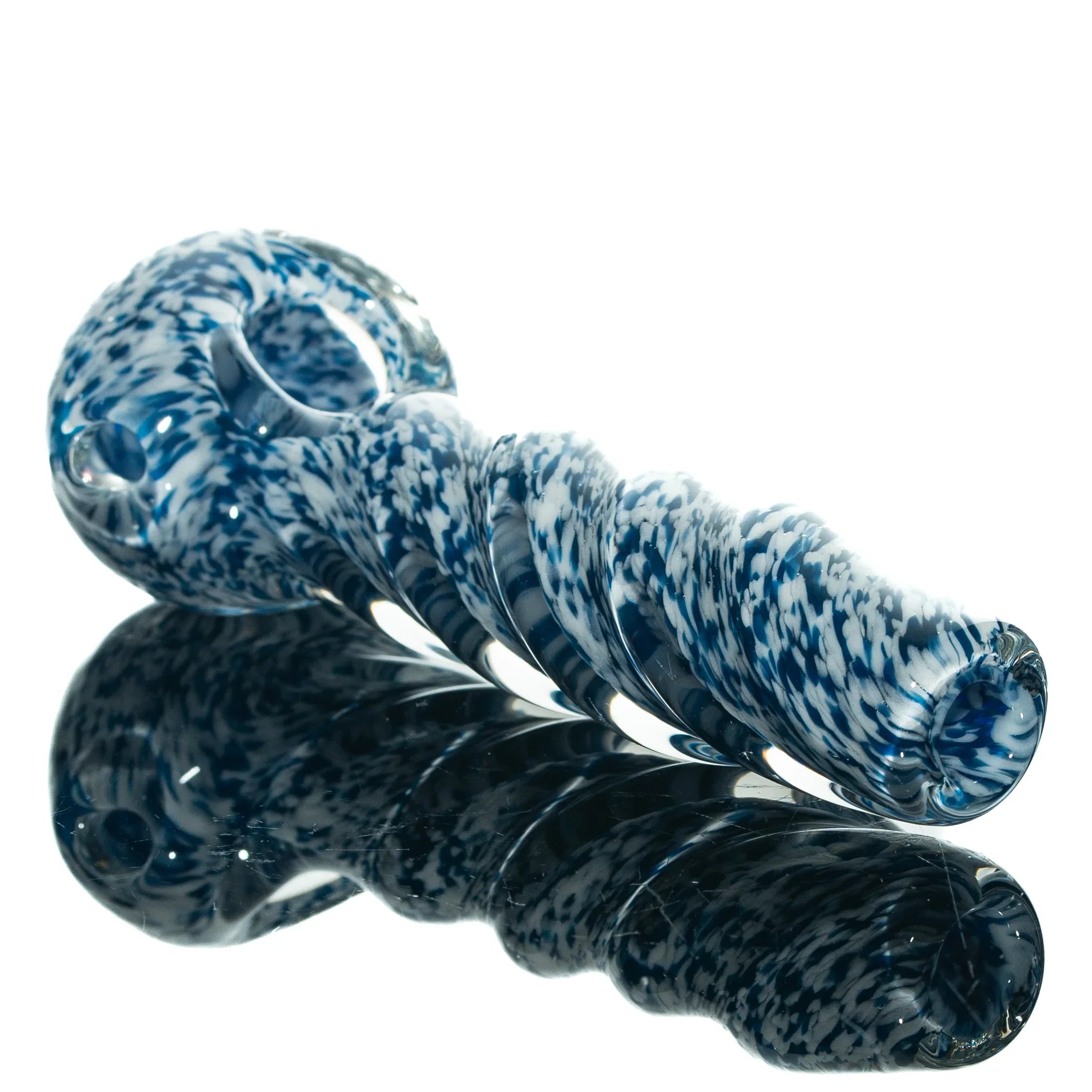Blue and white frit twist glass hand pipe with spiral design on reflective surface