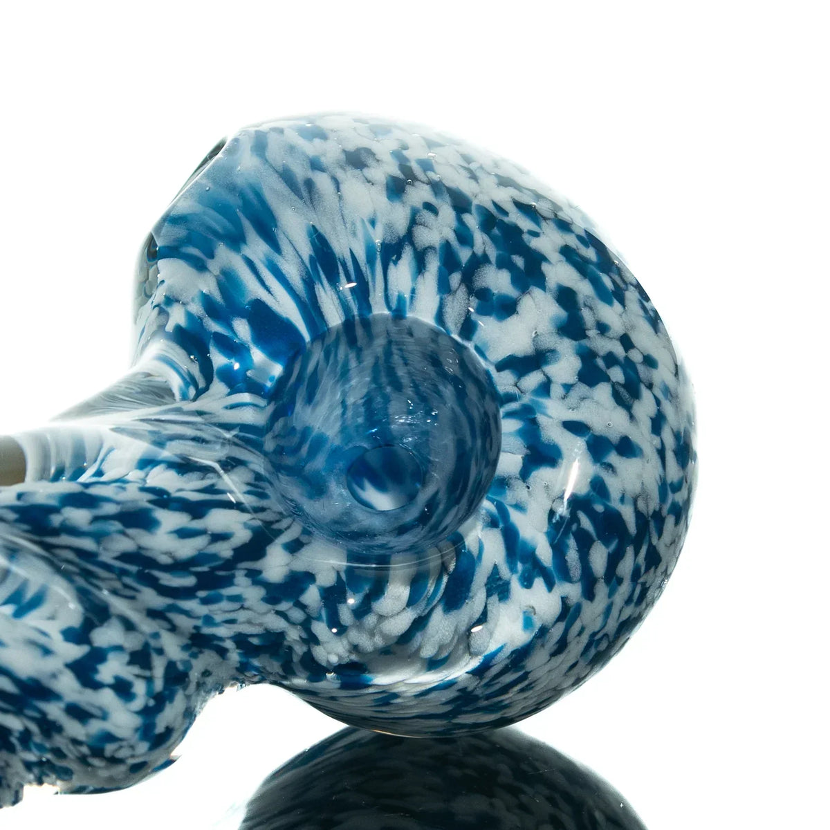 Blue and white frit glass hand pipe with twist design on reflective surface