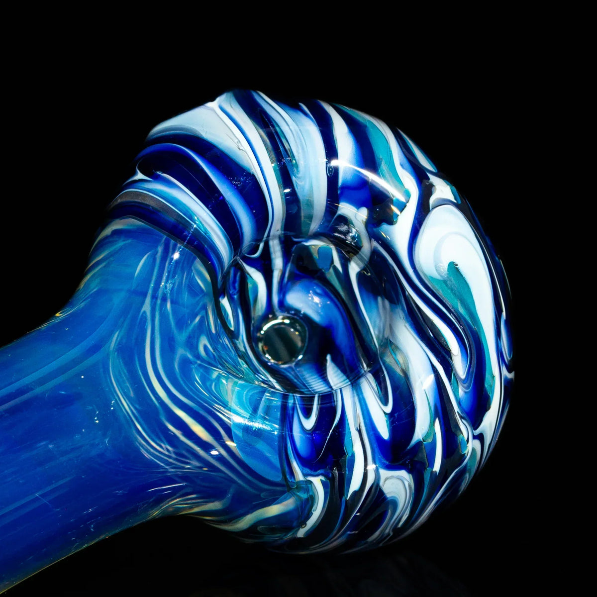 Blue and white swirl glass spoon pipe with vibrant fume design on black background