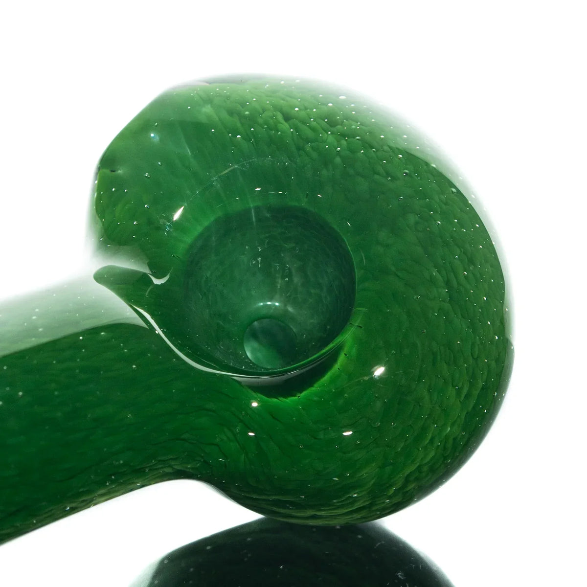 Close-up of a green glass hand pipe with textured frit design and deep bowl