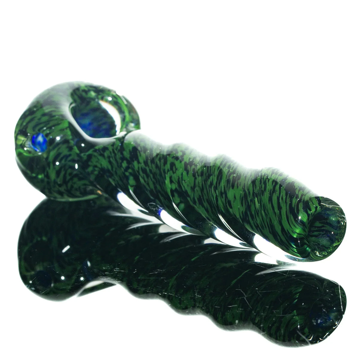 Green and black glass twist hand pipe with frit design on a reflective surface