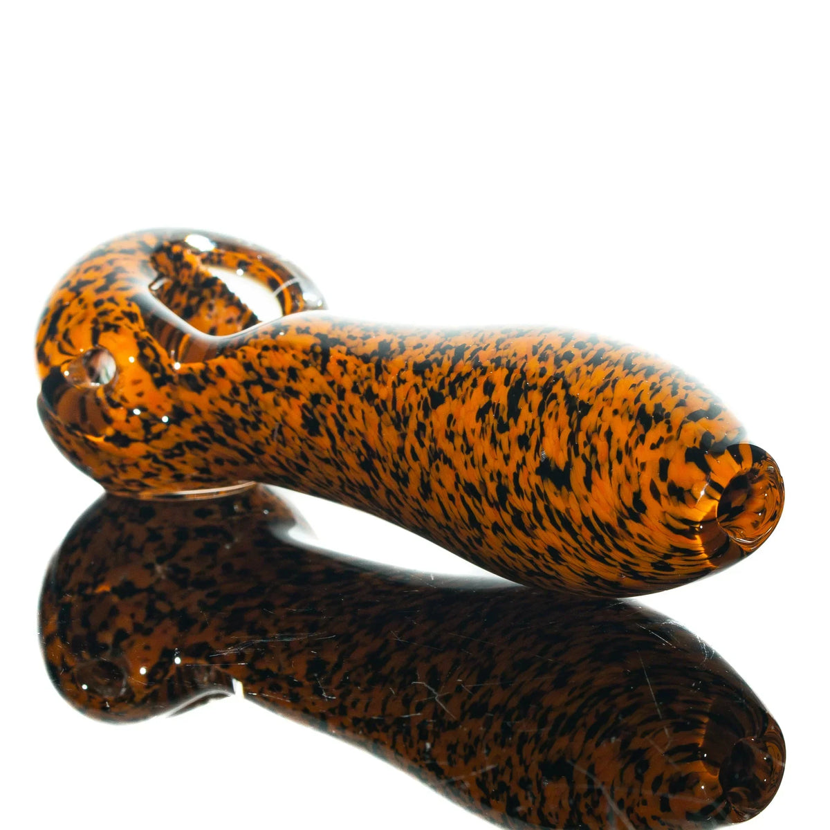 Orange and black frit glass spoon pipe with glossy finish on white background