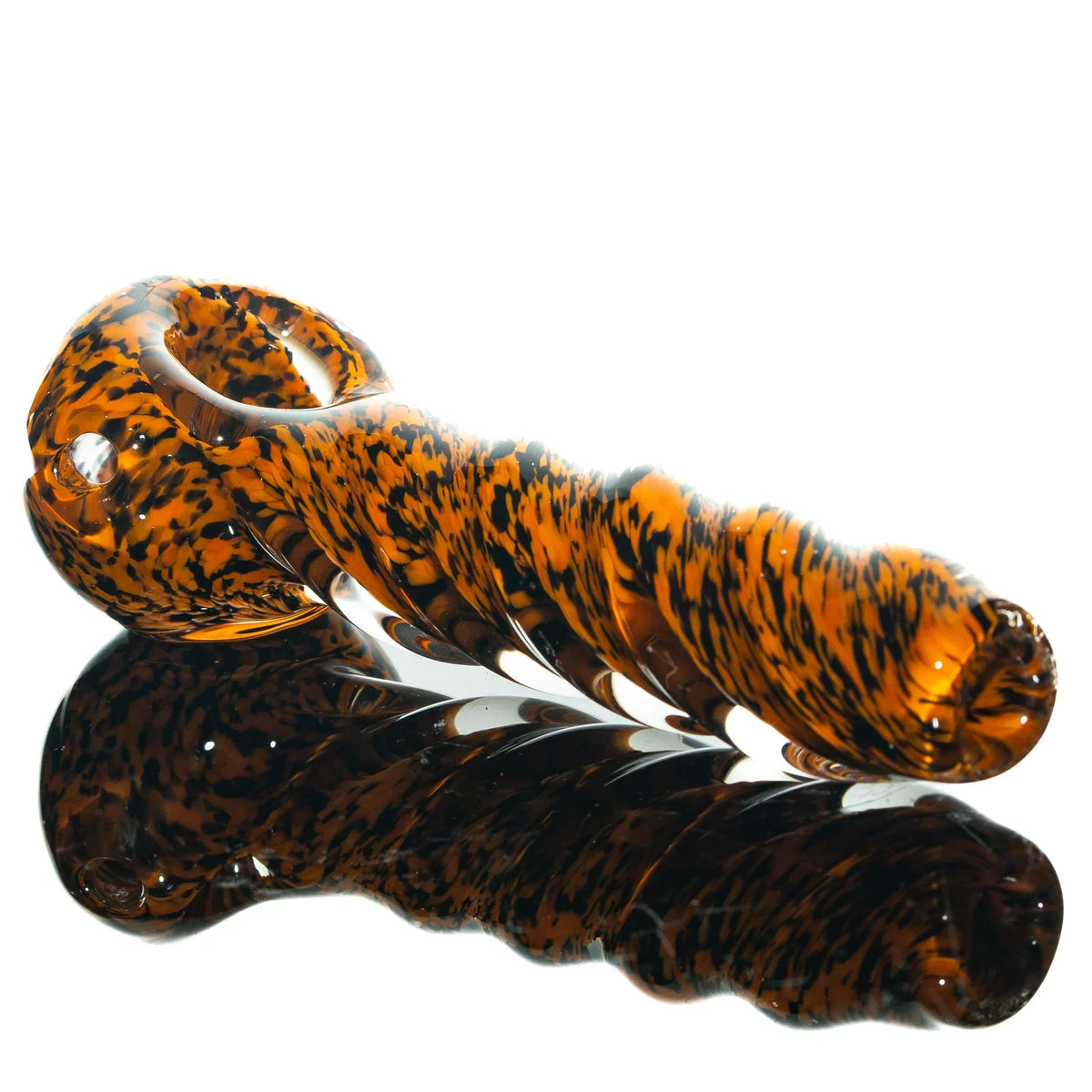 Orange and black frit glass hand pipe with twisted design on white background