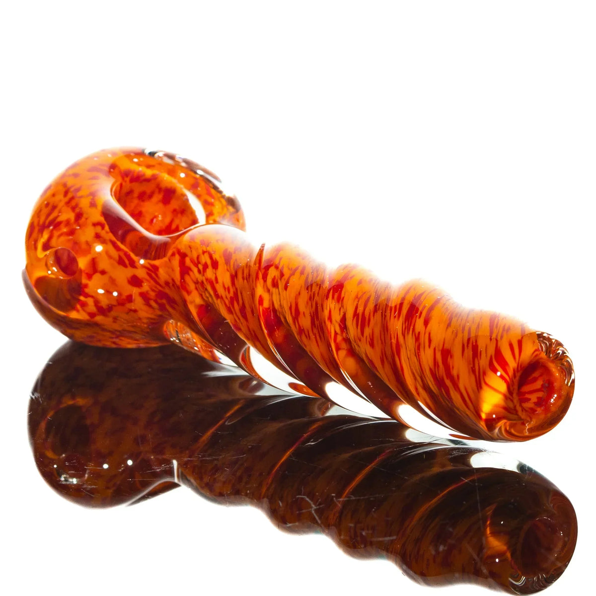 Handblown orange and red twist glass pipe with frit design on reflective surface
